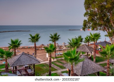 Palm Trees And Sun Loungers On The Mediterranean Beach At Sunrise, Turkey