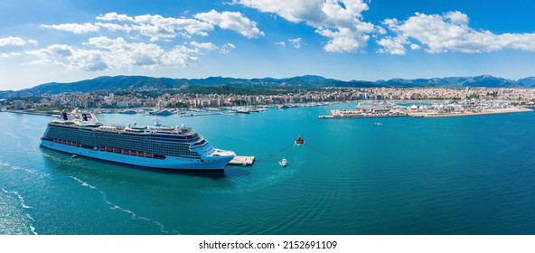 Palma, Balearic Islands, Spain – May 1, 2022: A large cruise ship moored at the port of Palma de Mallorca at daytime. The huge cruise ships bringing tourists for one day to look at the town