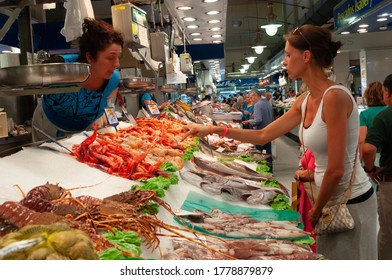 Palma de Mallorca, Balearic Islands/Spain; july 2014: woman buying at a fish stall in the Mercado del Olivar, Palma de Mallorca