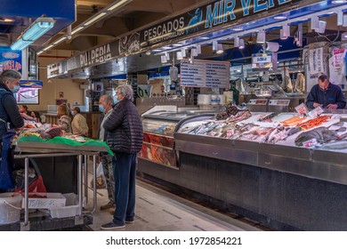 Palma de Mallorca, Spain; april 23 2021: Shoppers and vendors wearing facial masks at a fish market in the traditional Mercado del Olivar. New normality during the Covid-19 pandemic