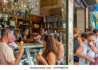 Palma De Mallorca, Spain; August-23, 2022: People Standing Buying And Eating Ice Creams In An Ice Cream Parlor On A Summer Afternoon In Spain