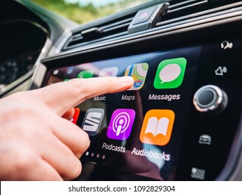 PALMA DE MALLORCA, SPAIN - MAY 10, 2018: Woman Pressing Apple Maps Button On The Apple CarPlay Main Screen In Modern Car Dashboard During Driving On Spanish Holiday Highway 