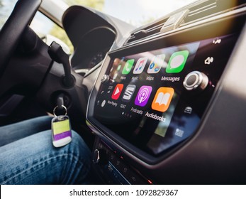 PALMA DE MALLORCA, SPAIN - MAY 10, 2018: Woman Driving Car With Apple CarPlay Main Screen Apps In Modern Car Dashboard During Driving On Spanish Holiday Highway