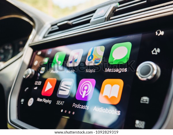 PALMA DE MALLORCA, SPAIN - MAY\
10, 2018: Side view of large dashboard computer screen with apps\
buttons on the Apple CarPlay main screen in modern car dashboard\

