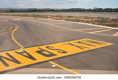 Palma, Spain - September 25, 2019: MAX SPAN Yellow Sign On Ground Of Mallorca Airport, Sun Shines To Empty Runways Near