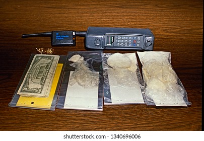 Palmer Park, Maryland, USA, 1989
Prince Georges County Police Display Cash Cell Phone, Powder And Crack Cocaine Seized From Street Level Dealer After An Undercover Bust.