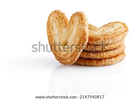 Palmier cookies or puff pastry ears isolated on white background. Cookies in the shape of a heart. Full depth of field. Closeup.