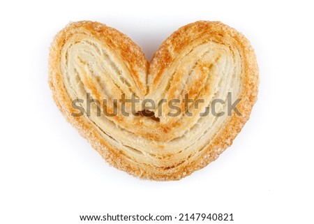 Palmier cookies or puff pastry ears isolated on white background. Cookies in the shape of a heart, top view. Closeup.