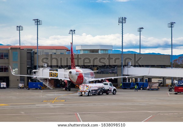 PALMIRA, COLOMBIA - OCTOBER, 2020: Fuel truck\
parking near airplane for fueling at the Alfonso Bonilla Aragon\
airport near Cali in\
Colombia