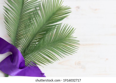 Palms And Purple Sash On White Wood Background