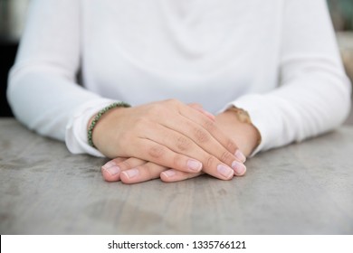 Palms Of Young Woman Sitting At Table Outdoors. Close-up Of Hands Of Caucasian Businesswoman Or Student In Outdoor Cafe. Body Language Concept