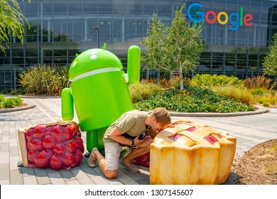 Palo Alto, USA. September 10, 2018. Young Man Sitting At The Google Office Near The Huge Android Sign In The Silicon Valley.