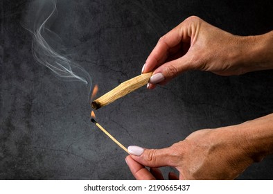 Palo Santo Burning In Front Of Dark Background