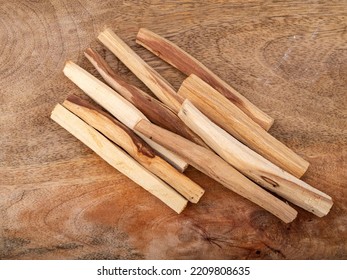 Palo Santo Burning In Front Of Wood Background