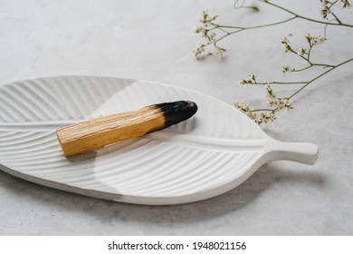 Palo Santo Wood On A White Ceramic  Plate. Healing, Meditation, Relaxation Concept