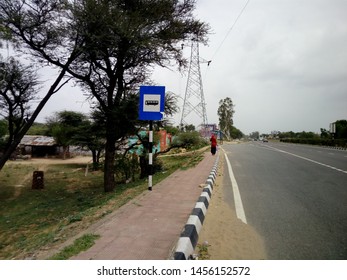 Palsana,Rajasthan/India-July 16, 2019: Blue And White Bus Stop Sign On National Highway 52 In India With Sky Background.