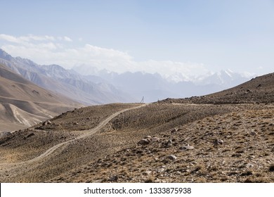 Pamir Highway In The Desert Landscape Of The Pamir Mountains In Tajikistan. Afghanistan Is On The Left