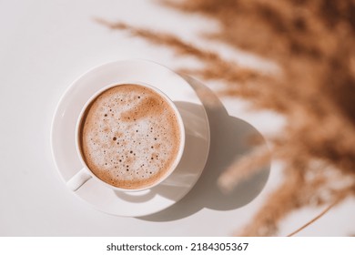 Pampas Grass And White Cup With Coffee. Drinking Cappuccino In The Breakfast Morning At Home. Flat Lay. Wallpaper. Aesthetics. Cozy Home