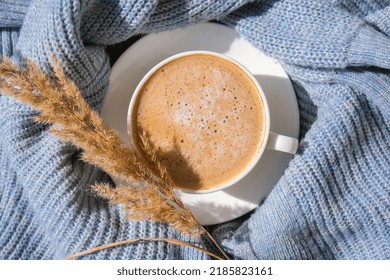 Pampas Grass And White Cup With Coffee On Blue Sweater. Drinking Cappuccino In The Breakfast Morning At Home. Flat Lay. Wallpaper. Aesthetics. Autumn Morning Concept Cozy Home