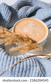 Pampas Grass And White Cup With Coffee On Blue Sweater. Drinking Cappuccino In The Breakfast Morning At Home. Flat Lay. Wallpaper. Aesthetics. Autumn Morning Concept Cozy Home