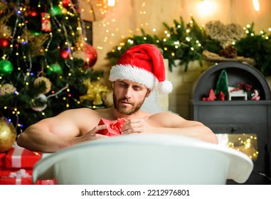 Pampering Myself. Holidays Relax. Christmas Tour Concept. Man Lying In Bathtub Relax With Gift Box. Sexy Macho Relax In Bathtub. Spa And Wellness. Enjoy New Years Eve Celebrations Book Stay Hotel