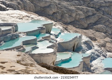 Pamukkale Travertine Terraces, amazing aqua blue pools of thermal mineral-rich spring water set against a geological rock formation, world heritage site and popular tourism destination  in Turkey - Shutterstock ID 2150234977