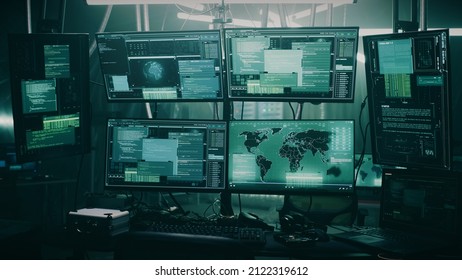 Pan around view of modern computer monitor with world map and various data located on desk in dark room of hacker base - Powered by Shutterstock