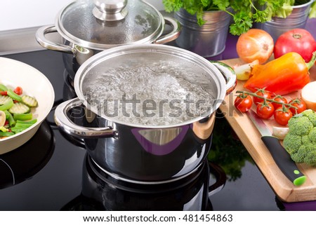 pan of boiling water on the cooker in the kitchen