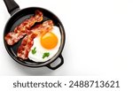 pan fried crispy pork Bacon and eggs sunny side up,  can be served scrambled, over easy, over hard.  Common breakfast meal served in America. Isolated on white background with copy space