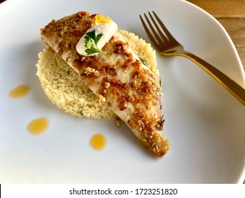 Pan fried dukkah crusted fish on a bed of couscous - Powered by Shutterstock