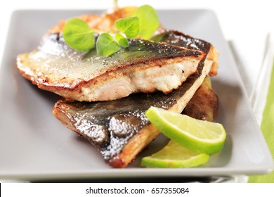Pan fried fish fillets and vegetable garnish