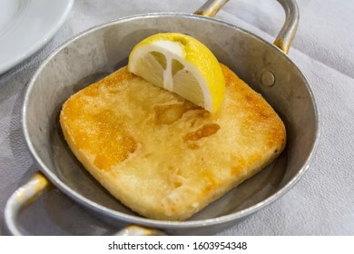 A Pan With Fried Halloumi Cheese And Lemon In Greece.