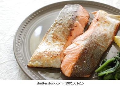 Pan Fried Hokkaido Salmon Fillet Served With Lemon And Spinach 
