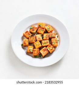 Pan Fried Paneer. Indian Roasted Cottage Cheese Bites On Plate Over White Background 