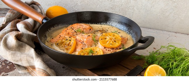 Pan With Fried Salmon In Creamy Sauce On The Table