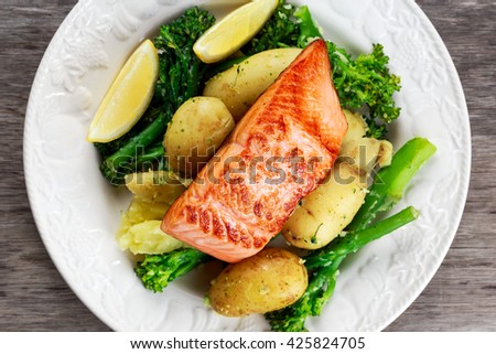 Pan fried Salmon Served with potatoes and tenderstem broccoli.