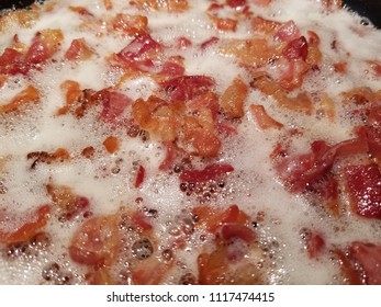 Pan Fried Sliced Hickory Smoked Bacon. A Bacon Background. 