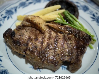 Pan Fried Steak Closeup,
Sirloin Steak With Portobello Mushroom, Baby Corn And Asparagus Closeup With Selective Focus On Background