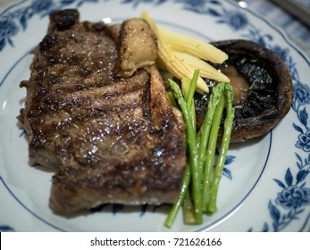 Pan Fried Steak Closeup,
Sirloin Steak With Portobello Mushroom, Baby Corn And Asparagus Closeup With Selective Focus On Background