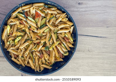 A pan with pasta  zucchini  tomatoes  and chorizo - Powered by Shutterstock