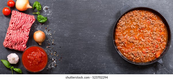 Pan Of Sauce Bolognese And Ingredients For Cooking, Top View With Copy Space.