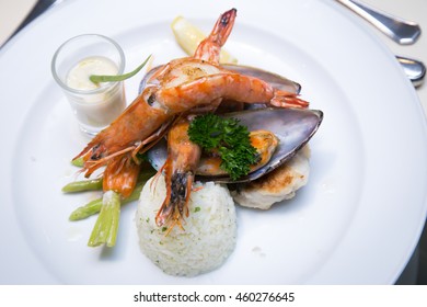 Pan Sear Sea Bass, Tiger Prawn, NZ Mussel, Garlic Rice With Market Vetetable And Cream Leek Sauce