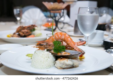 Pan Sear Sea Bass, Tiger Prawn, NZ Mussel, Garlic Rice With Market Vetetable And Cream Leek Sauce