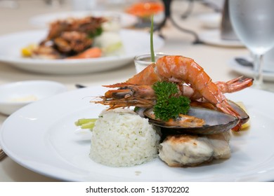 Pan Sear Sea Bass, Tiger Prawn, NZ Mussel, Garlic Rice With Market Vetetable And Cream Leek Sauce