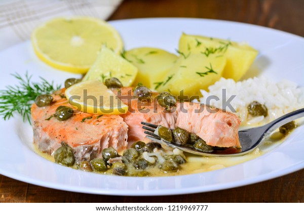 Pan seared salmon with\
lemon garlic caper butter sauce. Salmon piccata with rice and\
boiled potatoes.