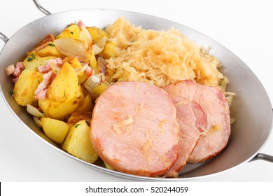 A pan with smoked pork chop an potatoes