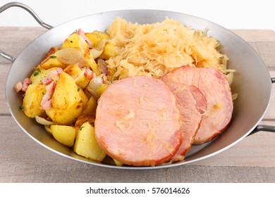 A Pan With Smoked Pork Chop An Potatoes