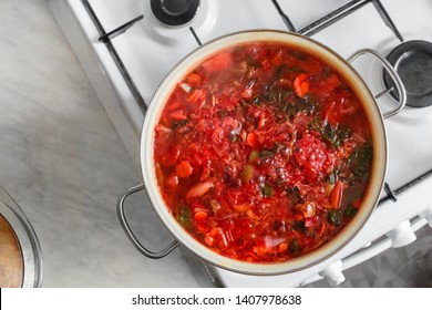 Pan Of Vegetable Soup On Gas Stove. View From Above