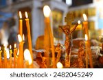 Panakhida, funeral liturgy in the Orthodox Church. Christians light candles in front of the Orthodox cross with a crucifix, pray for the dead. The concept of Orthodox faith and religion.