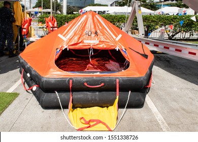 Panama City, Panama - Nov 3rd, 2019 - Life raft presented in the street in Panama city on public holiday in Panama. Orange inflatable, life rescue boat.